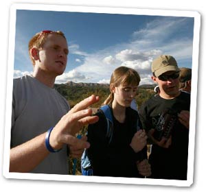 Ryan Charlston describes the view from Saqsayhuaman down to Cusco. Andrew Johnson and Alysha Jeans pretend to listen.